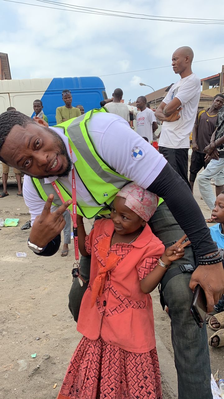 A BMW Cares volunteer with a child at an outreach